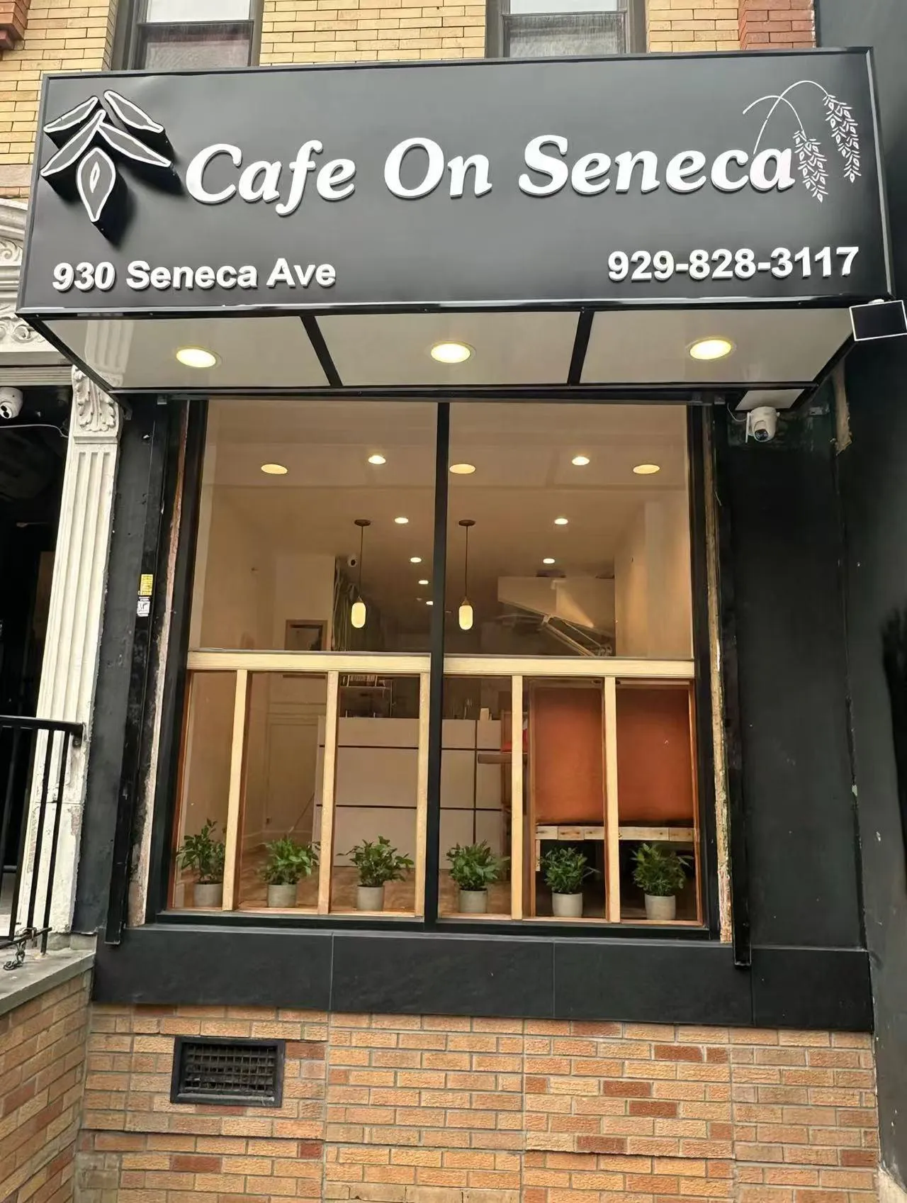Brick building storefront with black Cafe On Seneca sign, address and phone number at Cafe On Seneca, an Asian Fusion Restaurant in Ridgewood